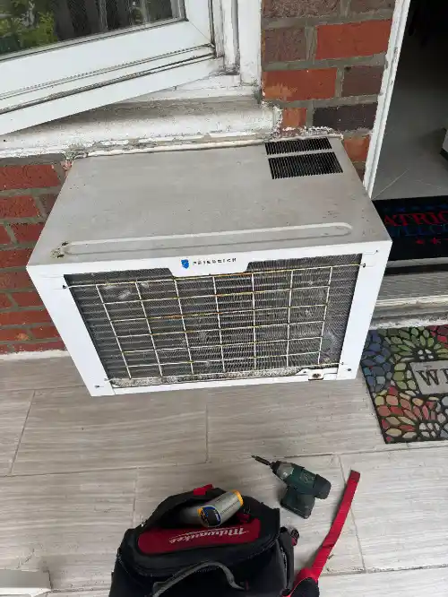 Reinstalled window air conditioner indoor view after service