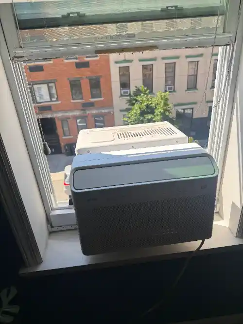 Window AC disassembly with internal components exposed during diagnostics